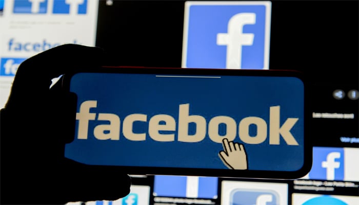 Facebook logo is displayed on mobile phone in this picture illustration taken December 2, 2019. — Reuters