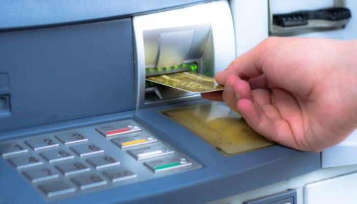An undated image of a person using ATM. — iStock