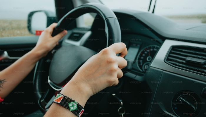 An undated image of a person driving car. — Unsplash
