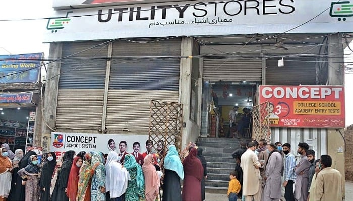 A large number of people standing in queues outside a Utility Store to purchase daily commodities during the Holy Month of Ramzan ul Mubarak. — APP