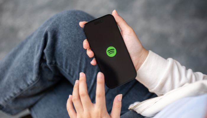 An undated image of a person using Spotify. — Canva