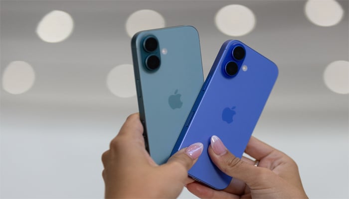 An attendee holds two iPhones 16 as Apple holds an event at the Steve Jobs Theater on its campus in Cupertino, California, US, September 9, 2024. — Reuters