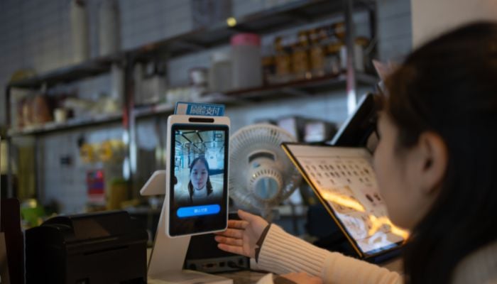 An undated image of a girl using face recognition feature. — Canva