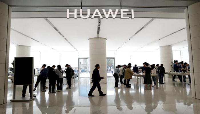 Customers shop at Huaweis flagship store in Beijing, China, April 18, 2024. — Reuters