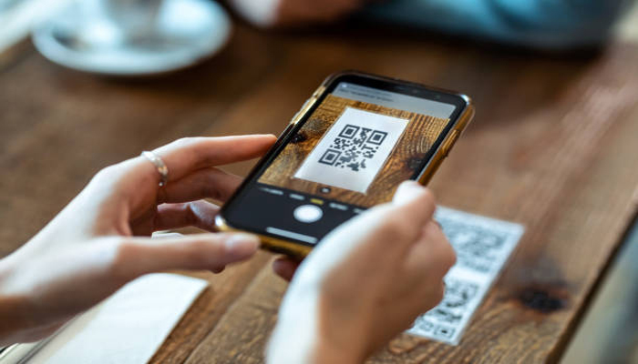 An undated image of a person scanning QR code. — iStock