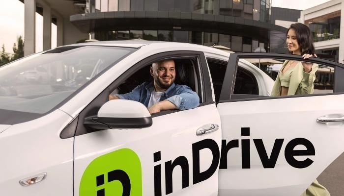 An undated image of a girl using the inDrive service. — inDrive
