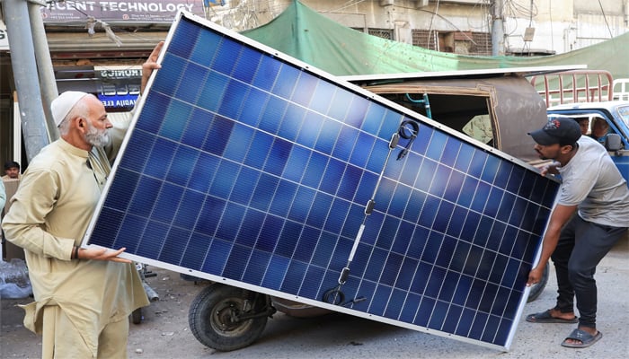 Men load solar panels on a rickshaw (tuk tuk) at market, in Karachi, Pakistan March 26, 2025. — Reuters