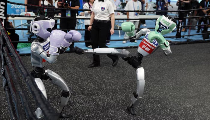 Unitree Robotics humanoid robots compete in a kickboxing match at the inaugural World Humanoid Robot Games, at the National Speed Skating Oval in Beijing, China August 15, 2025. — Reuters