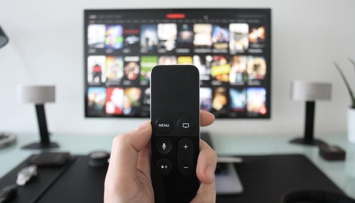 An undated image of a person watching TV. — Canva