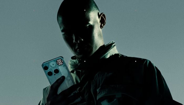 An undated image of a person holding a Nothing Phone (3). — Nothing