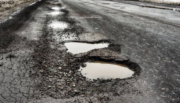 An undated image of a damaged road. — iStock