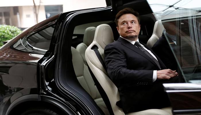 Tesla Chief Executive Officer Elon Musk gets in a Tesla car as he leaves a hotel in Beijing, China May 31, 2023. — Reuters