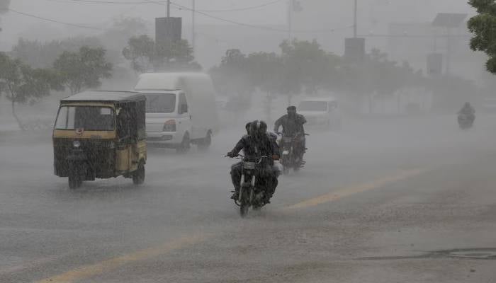 Commuters travel on a road during heavy rain in Karachi, Pakistan, August 20, 2025. — Reuters
